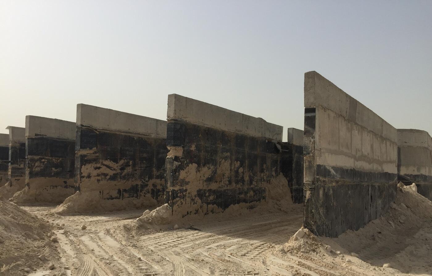 Concrete foundation walls with waterproof membrane exposed