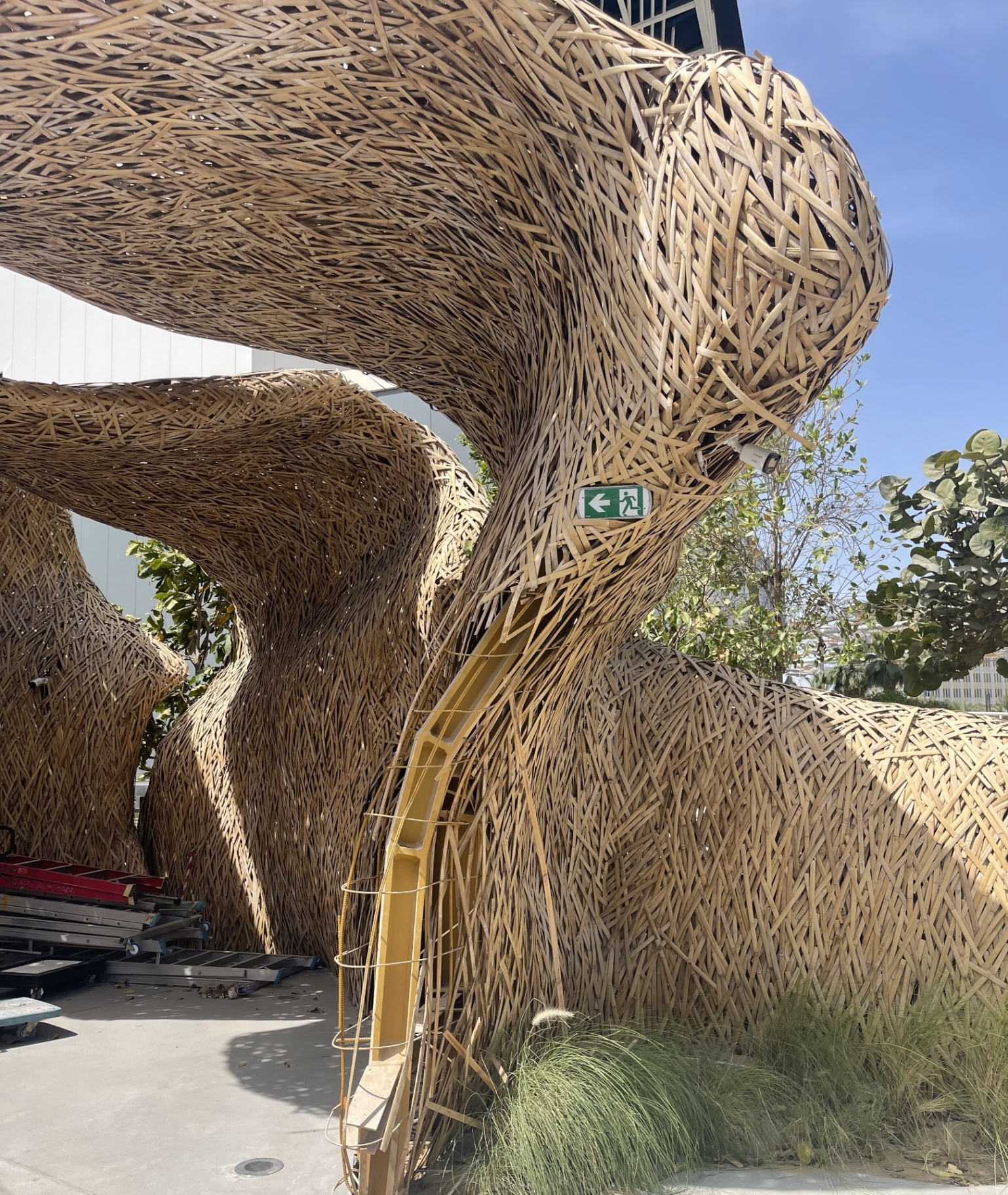 Woven bamboo curved structure with yellow steel support at ICD Pavilion