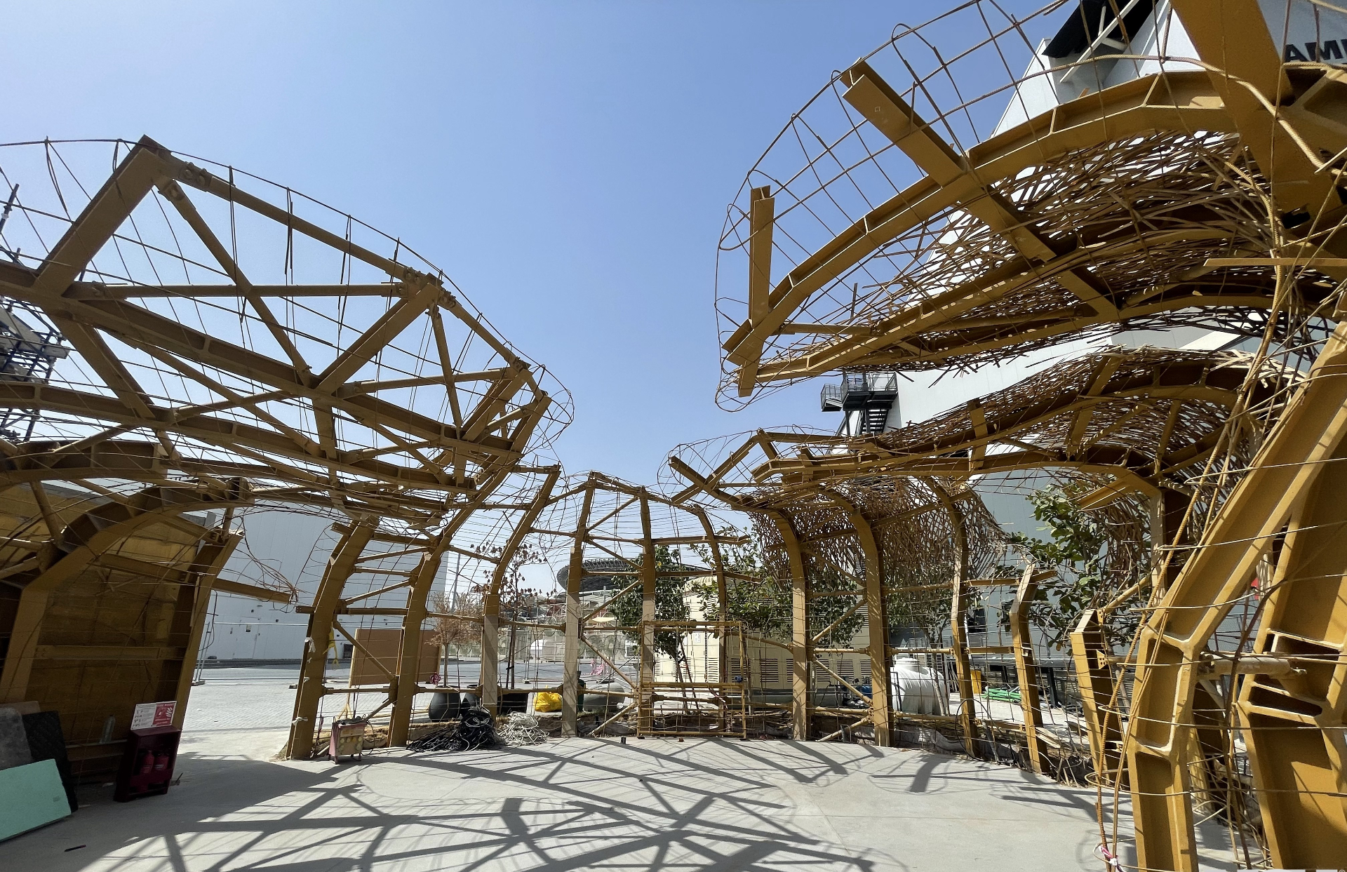 Wide view of ICD Pavilion arched steel framework during deconstruction
