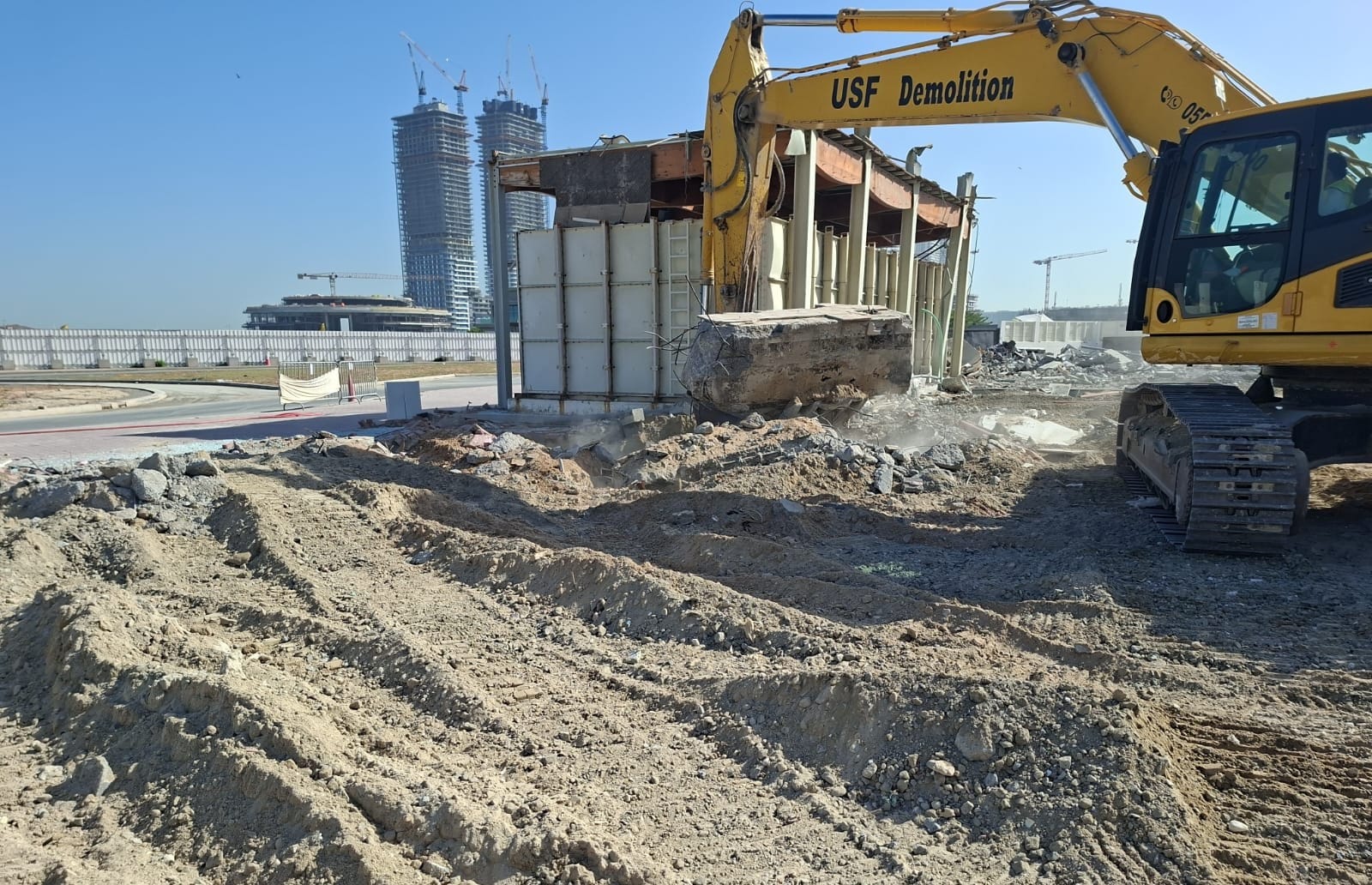 USF Demolition excavator working on cleared Zero Gravity Dubai Marina demolition site during final clearance phase June 2026