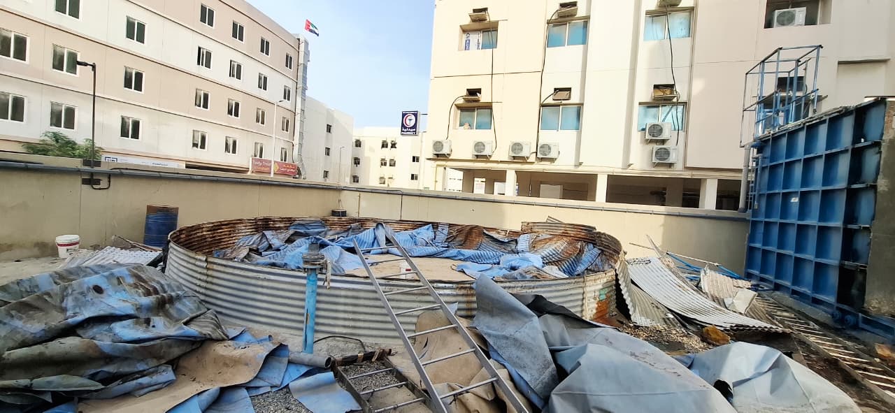 Partially dismantled GRP storage tank with debris cleared at Jebel Ali sewerage treatment plant site