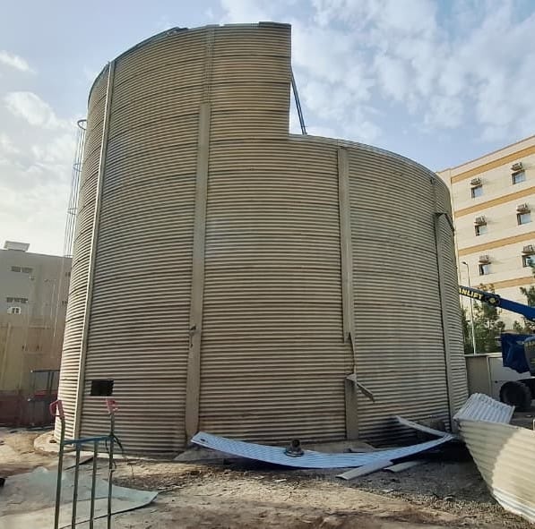 Large cylindrical storage tank with cut openings during USF Demolition Works decommissioning at Jebel Ali