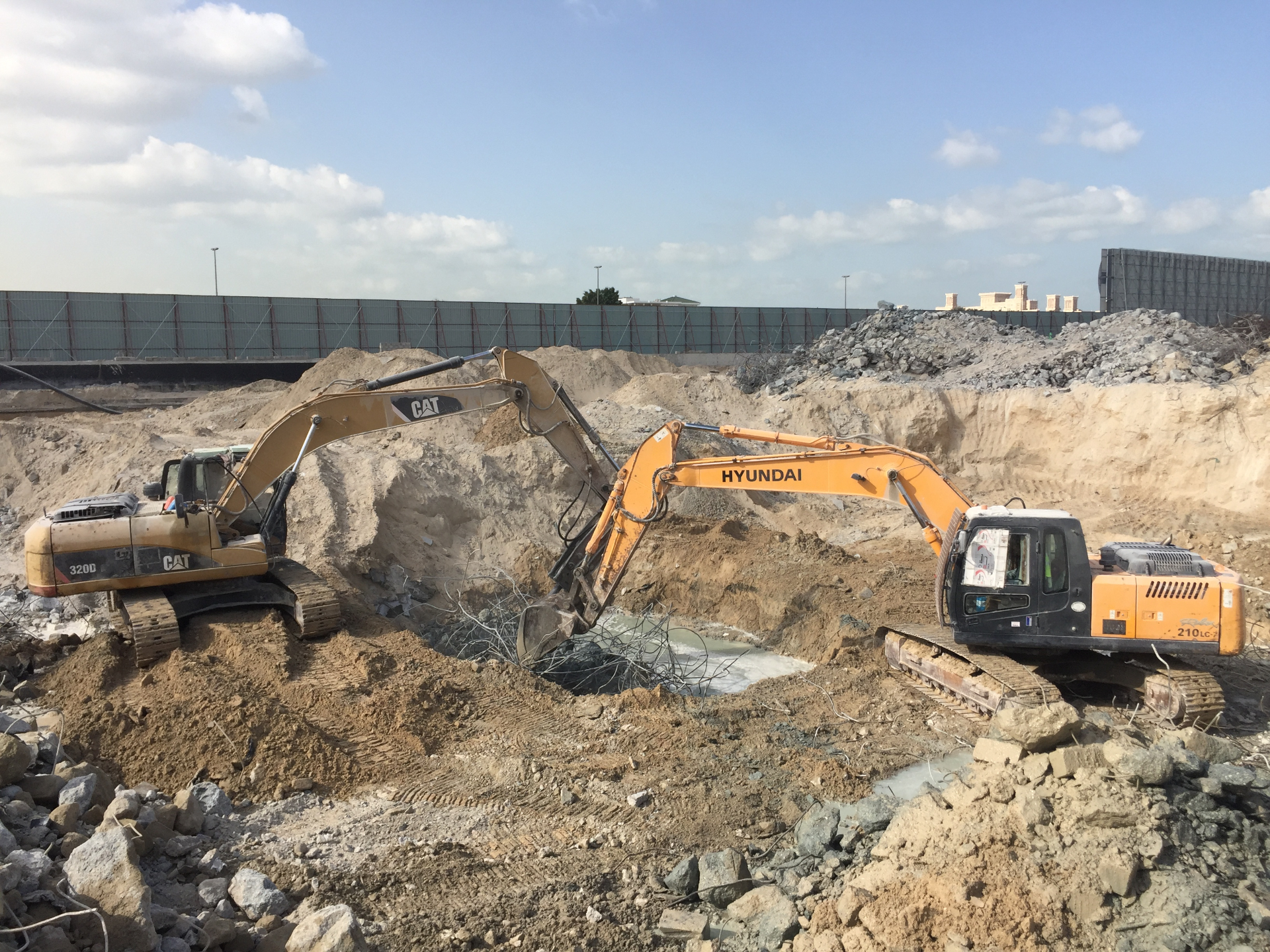 CAT and Hyundai excavators at final stage of villa demolition
