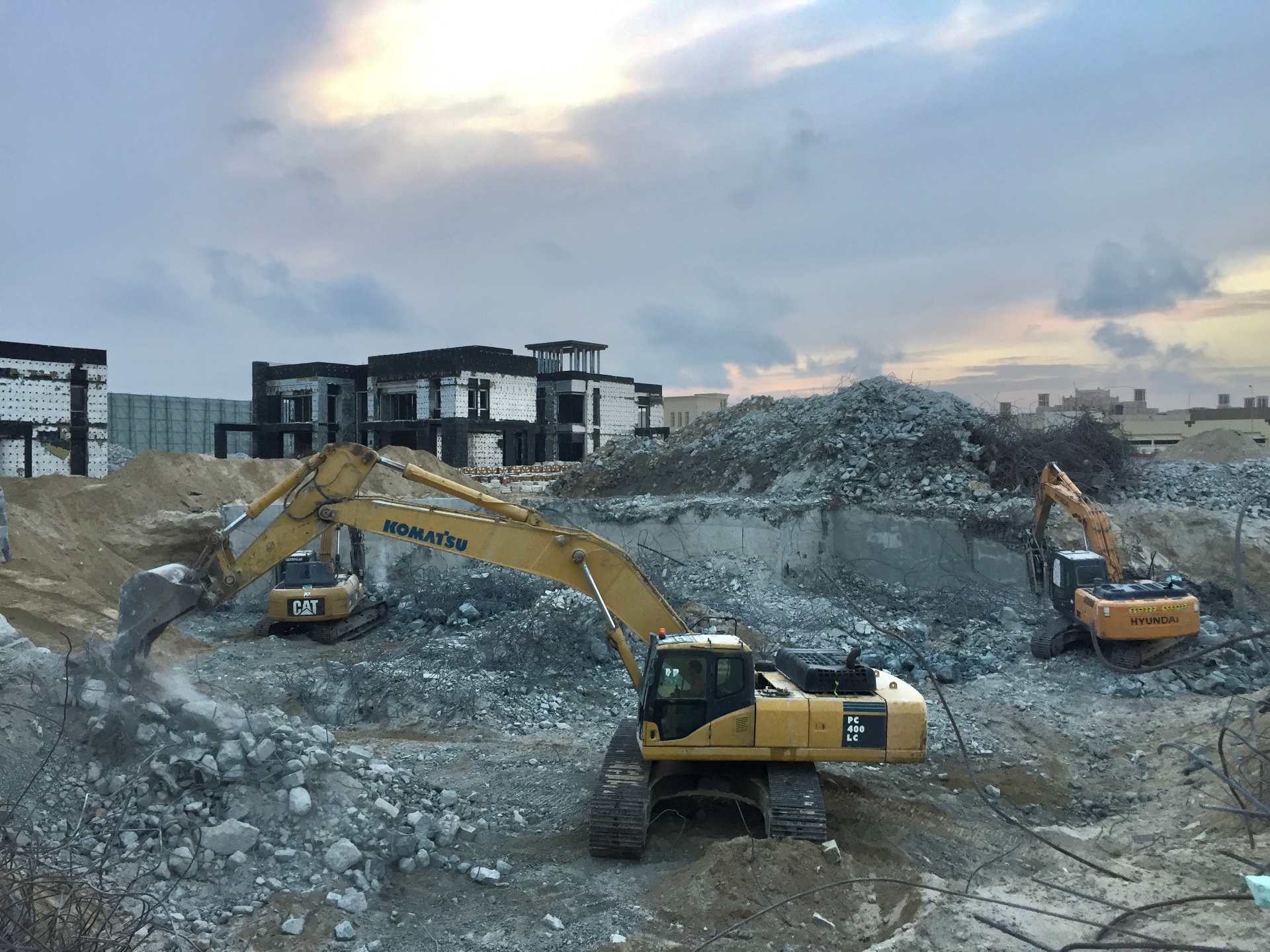 Multiple Komatsu excavators at large villa demolition project