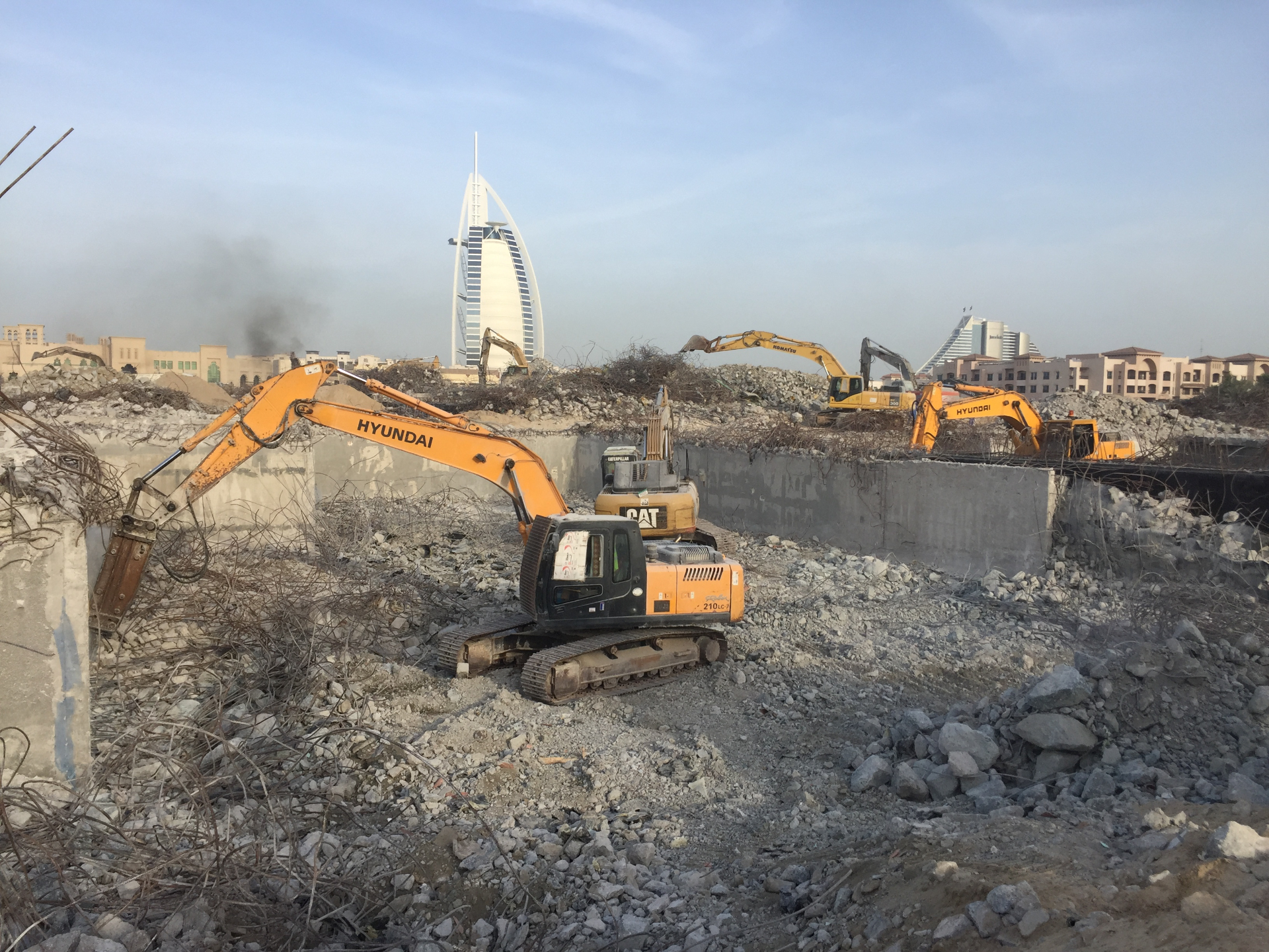 Hyundai excavators demolishing villas with Burj Al Arab view