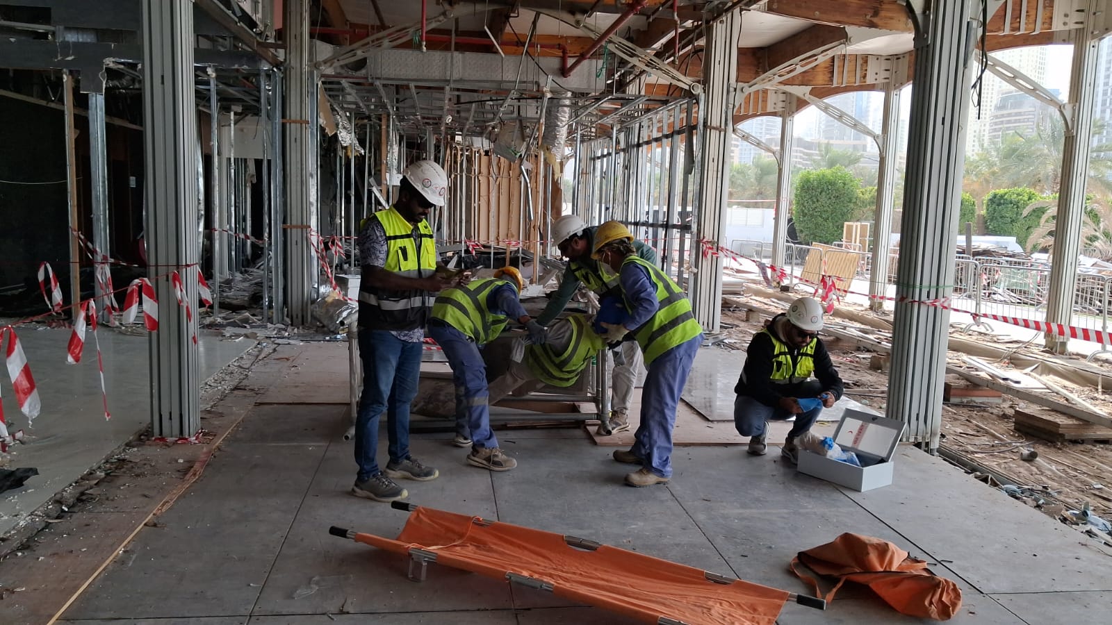 Safety team providing first aid and opening medical kit at Zero Gravity demolition site