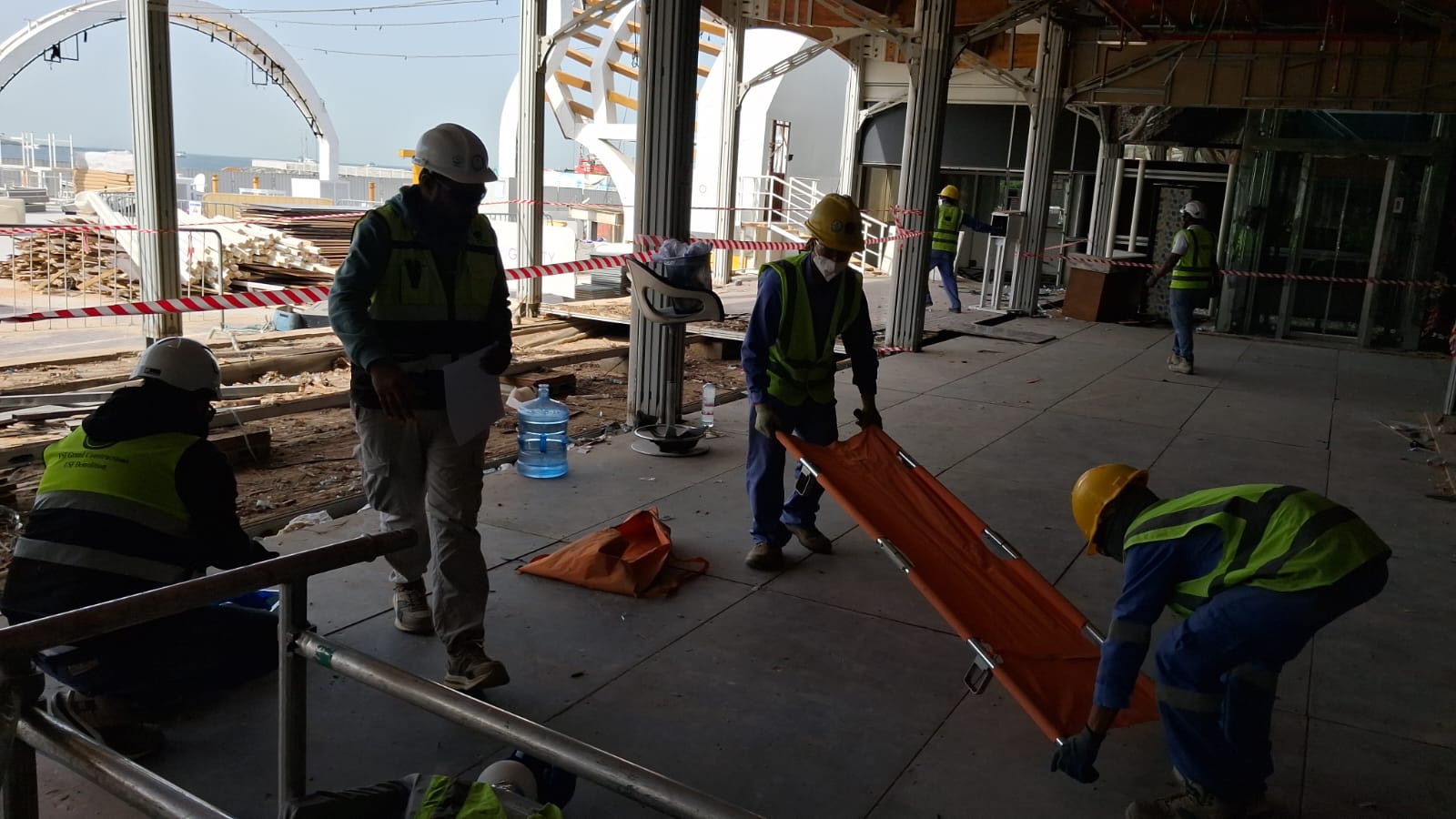 Emergency response team carrying stretcher with Dubai Marina architecture background