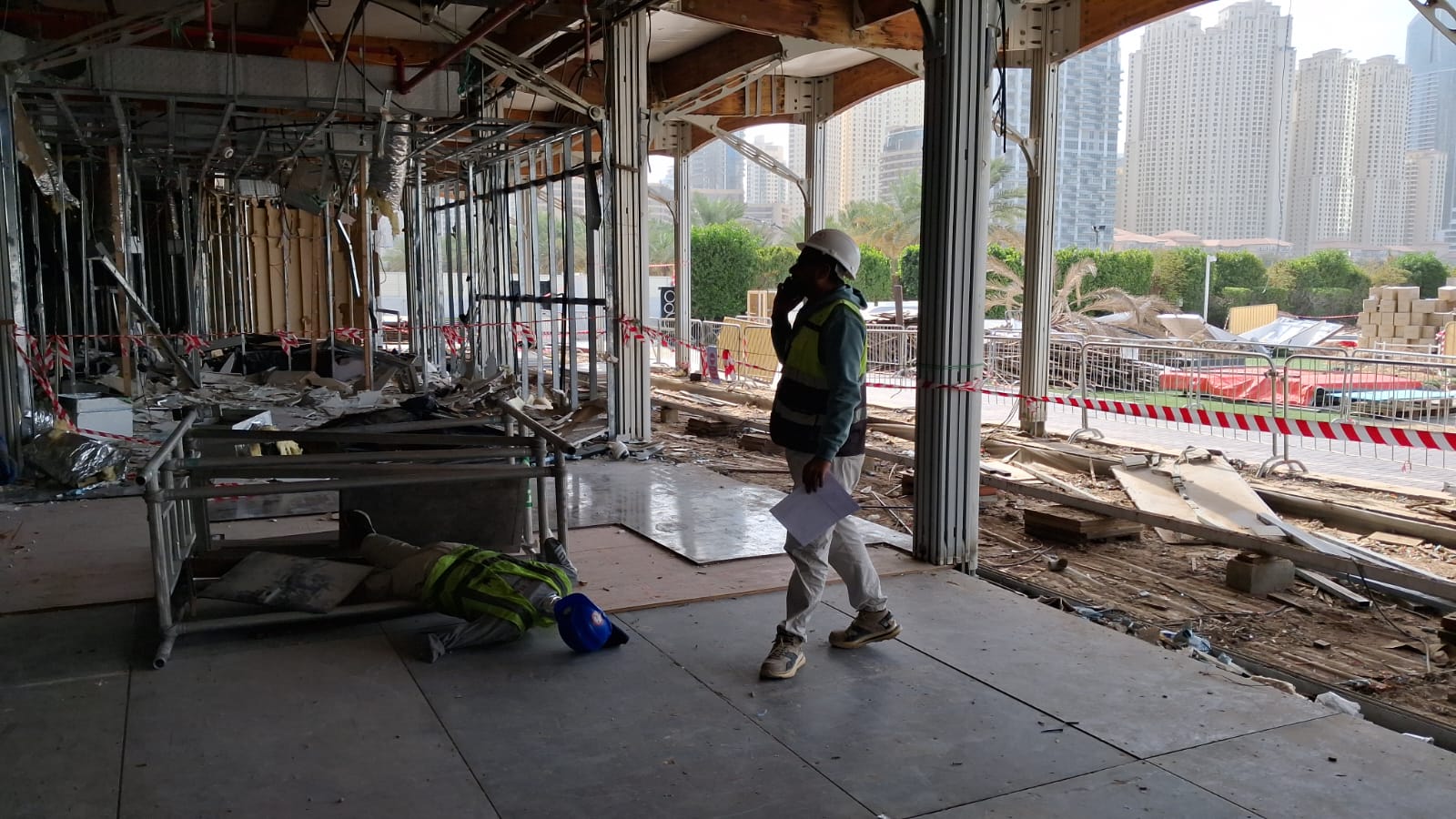 Safety supervisor making emergency call during fall-from-height drill