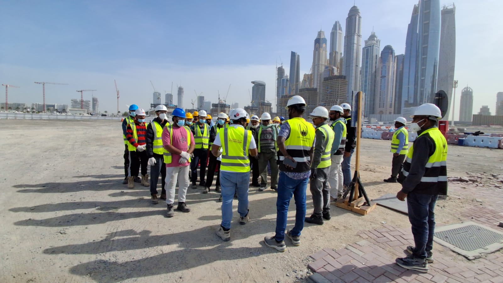 Construction workers receiving emergency response instructions at Marina Harbor site