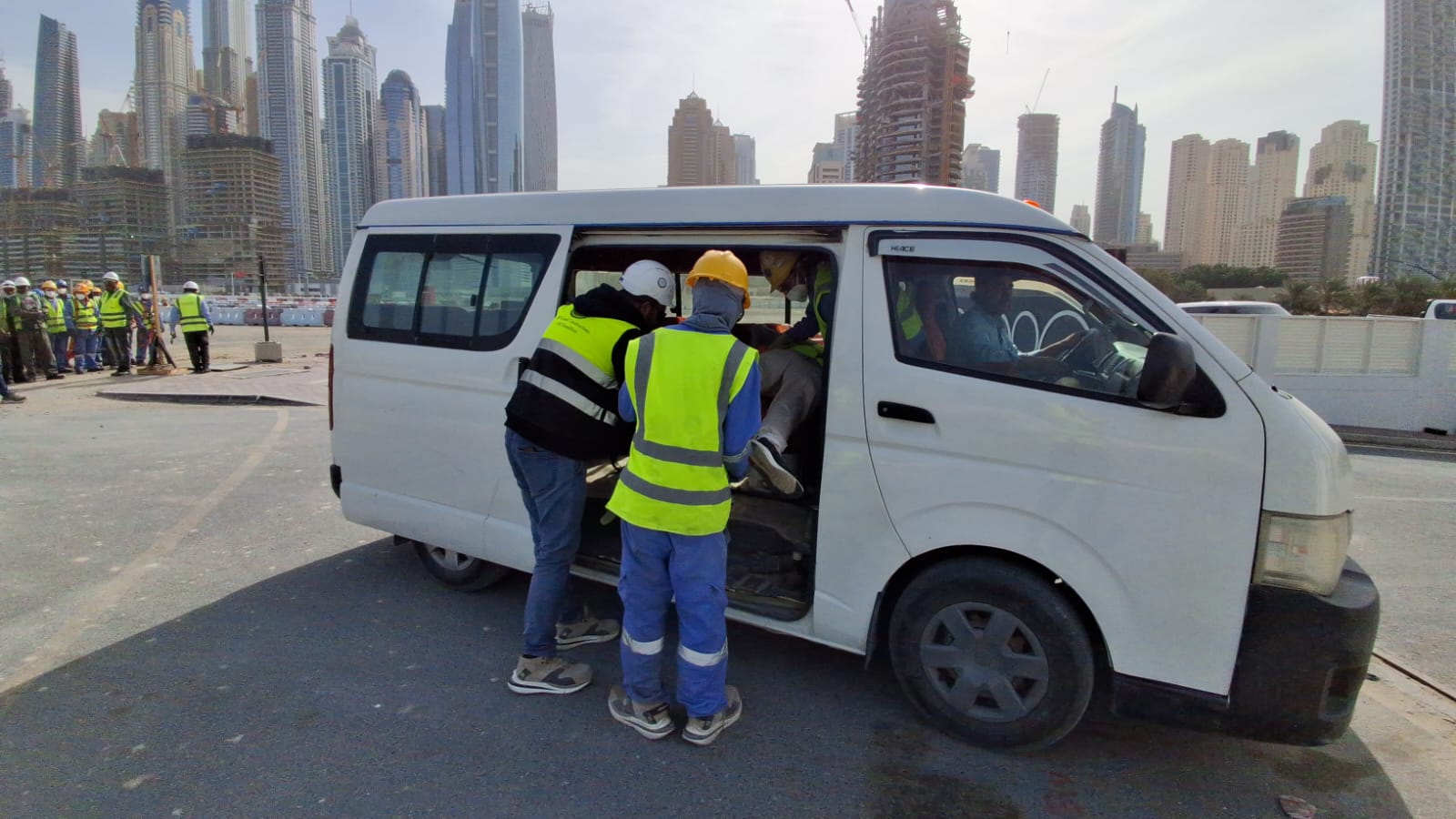 Emergency response team evacuating simulated injured personnel to vehicle