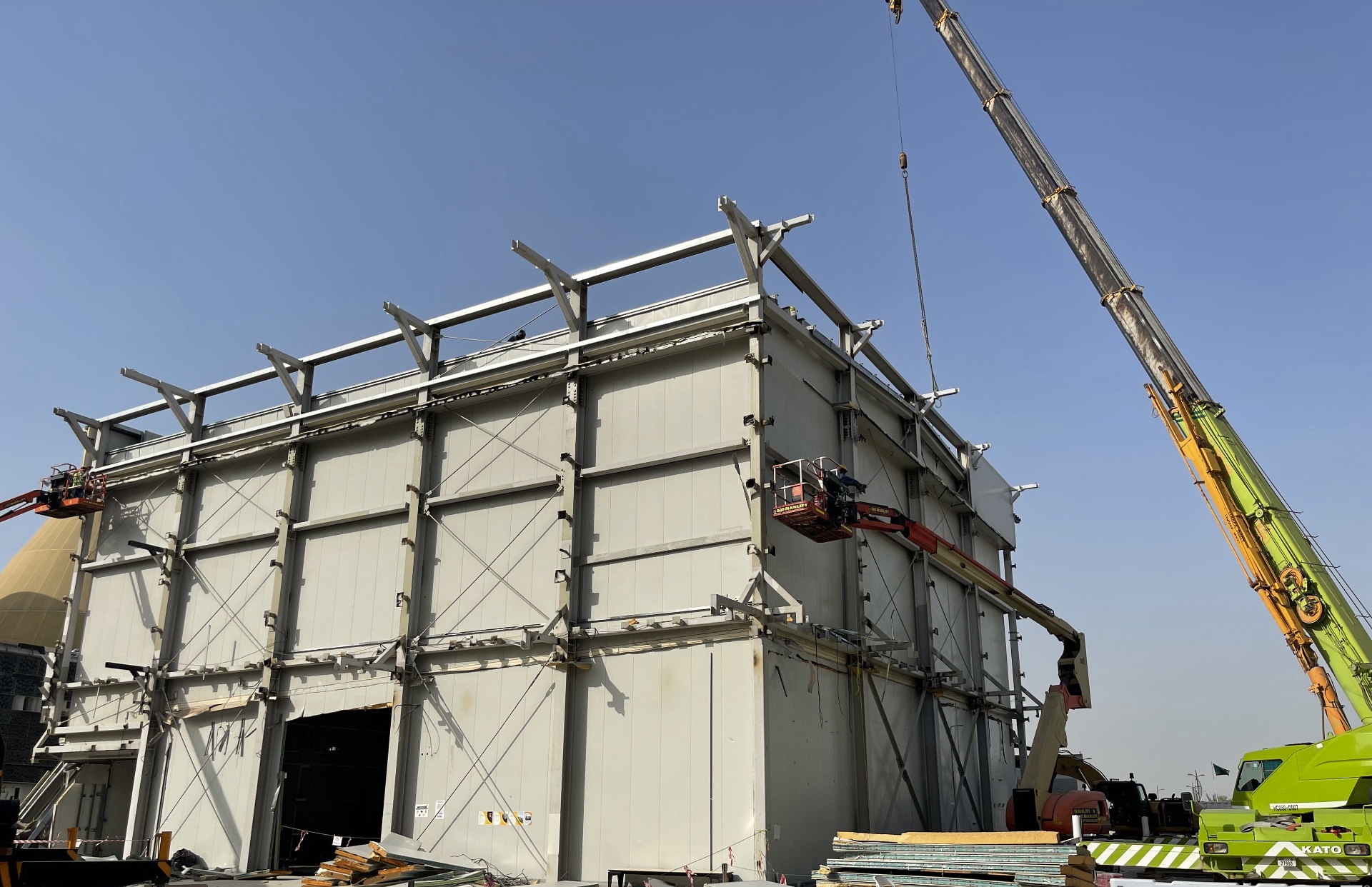 Multiple cranes dismantling New Zealand Pavilion steel structure