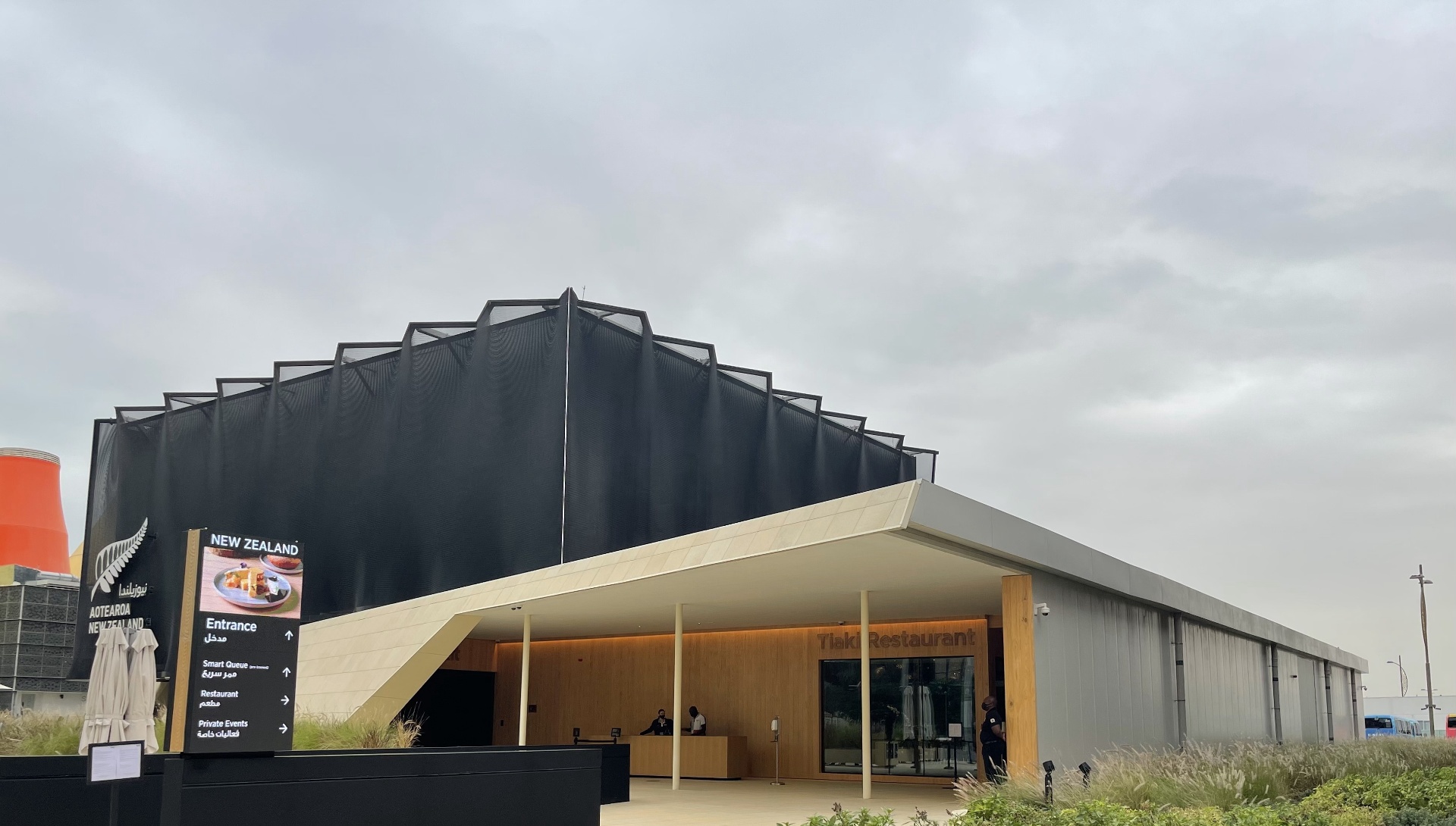 New Zealand Pavilion entrance with Tiaki Restaurant and wayfinding signage