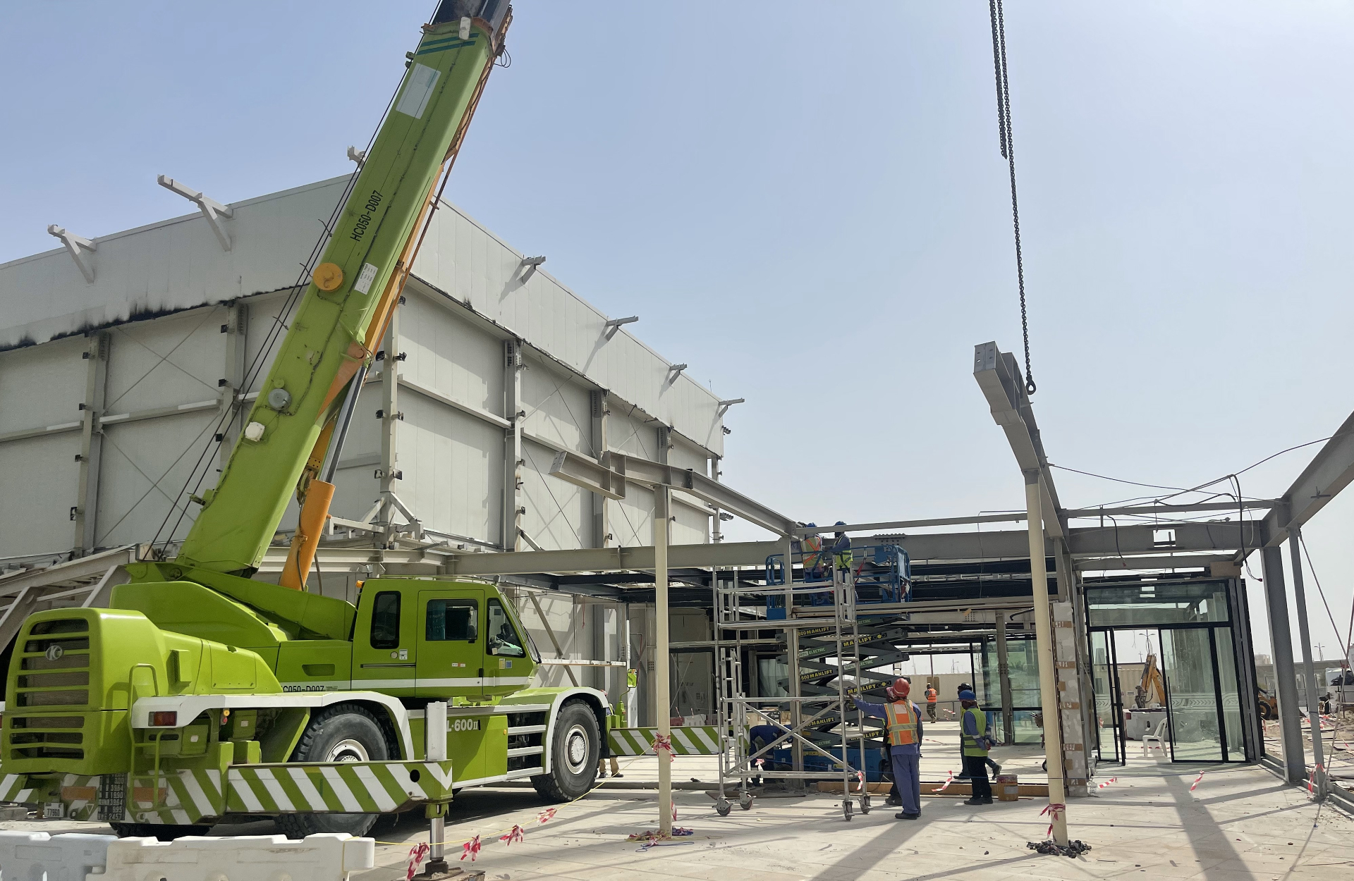 Green crane dismantling New Zealand Pavilion steel framework