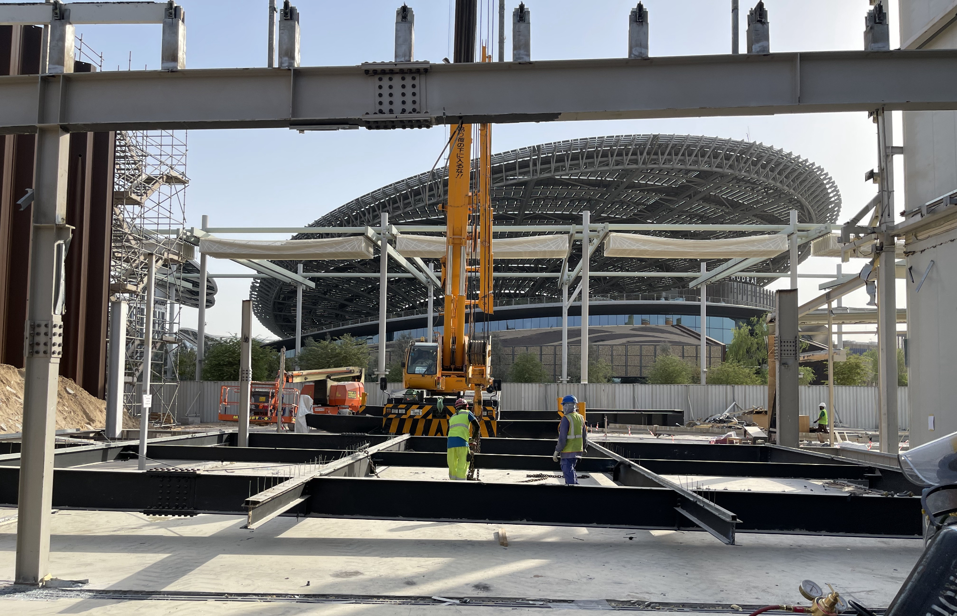 Steel framework removal with Al Wasl dome visible in background