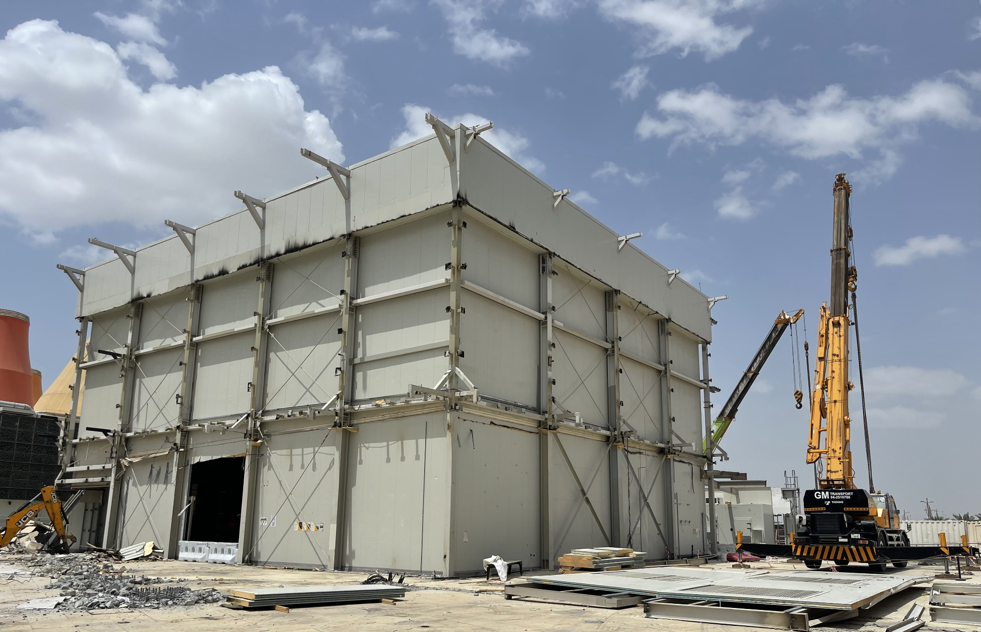 New Zealand Pavilion structure with exposed steel beams and crane