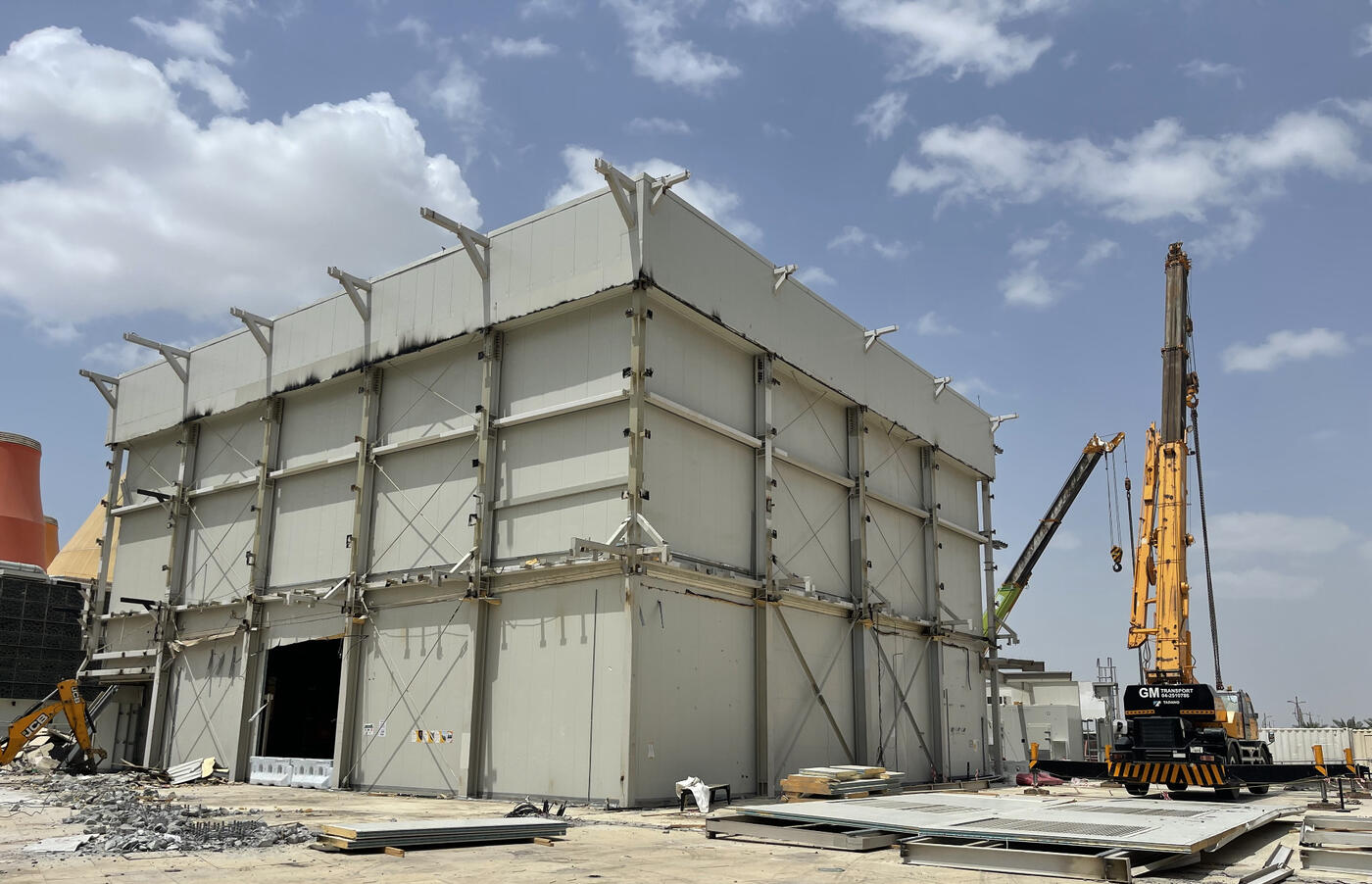 New Zealand Pavilion structure with exposed steel beams and crane