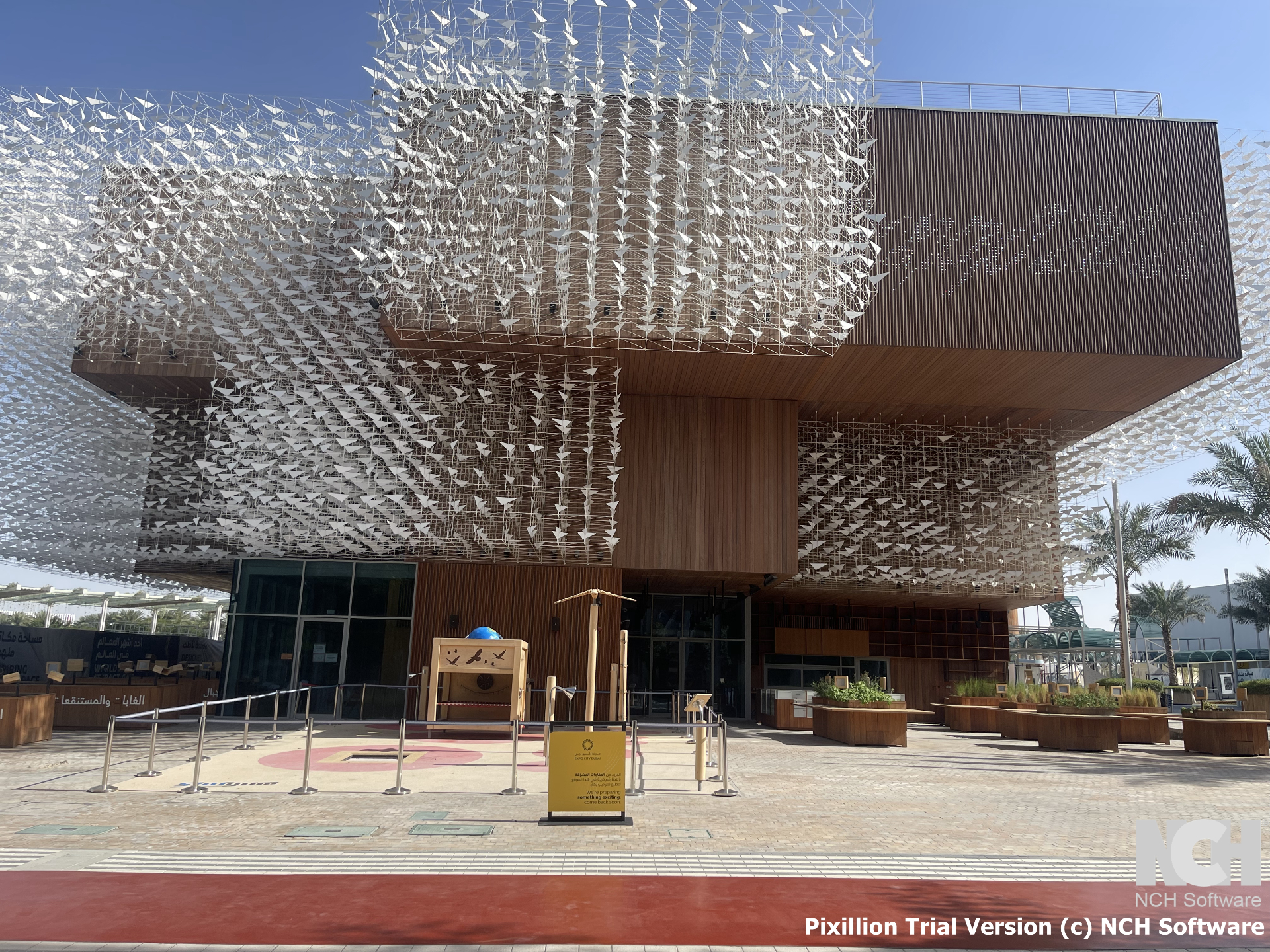 Poland Pavilion entrance with kinetic origami canopy and wooden exterior walls