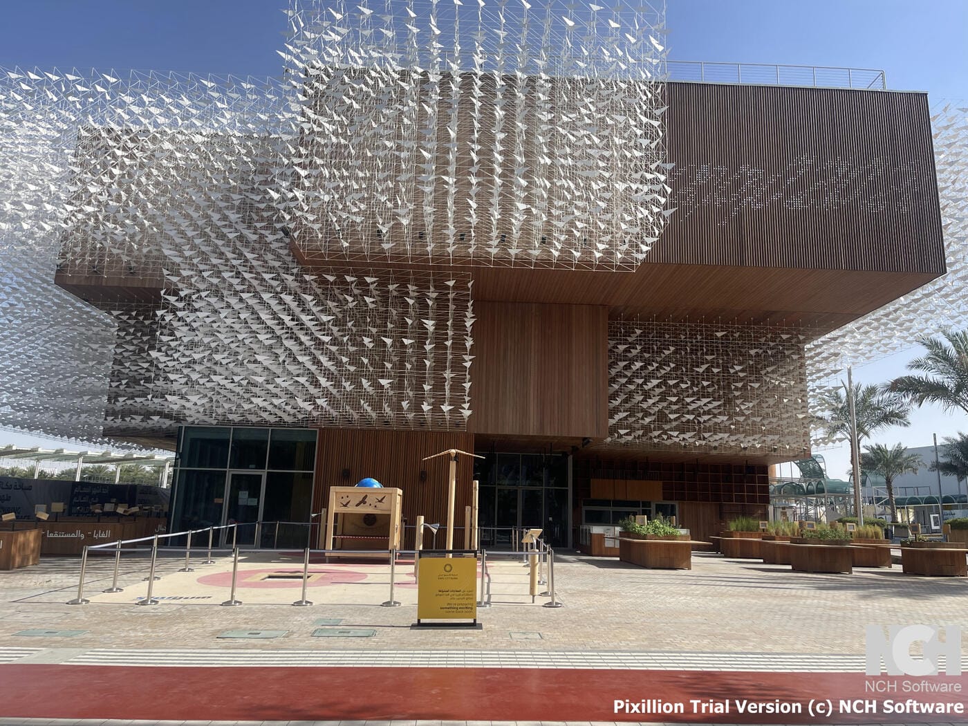 Poland Pavilion entrance with kinetic origami canopy and wooden exterior walls