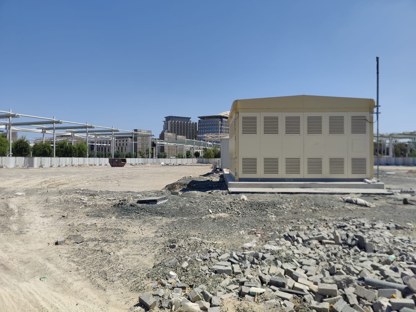 Cleared Poland Pavilion site with utility structure and debris after demolition