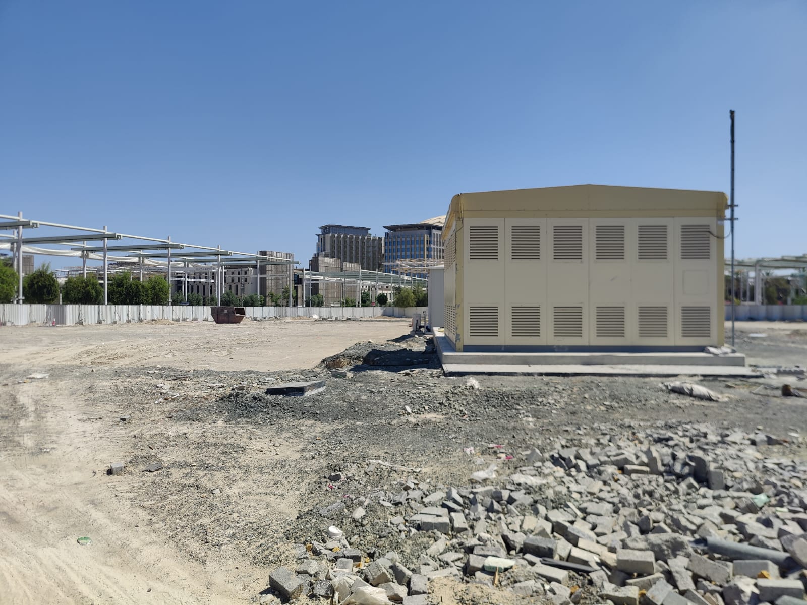 Cleared Poland Pavilion site with utility structure and debris after demolition