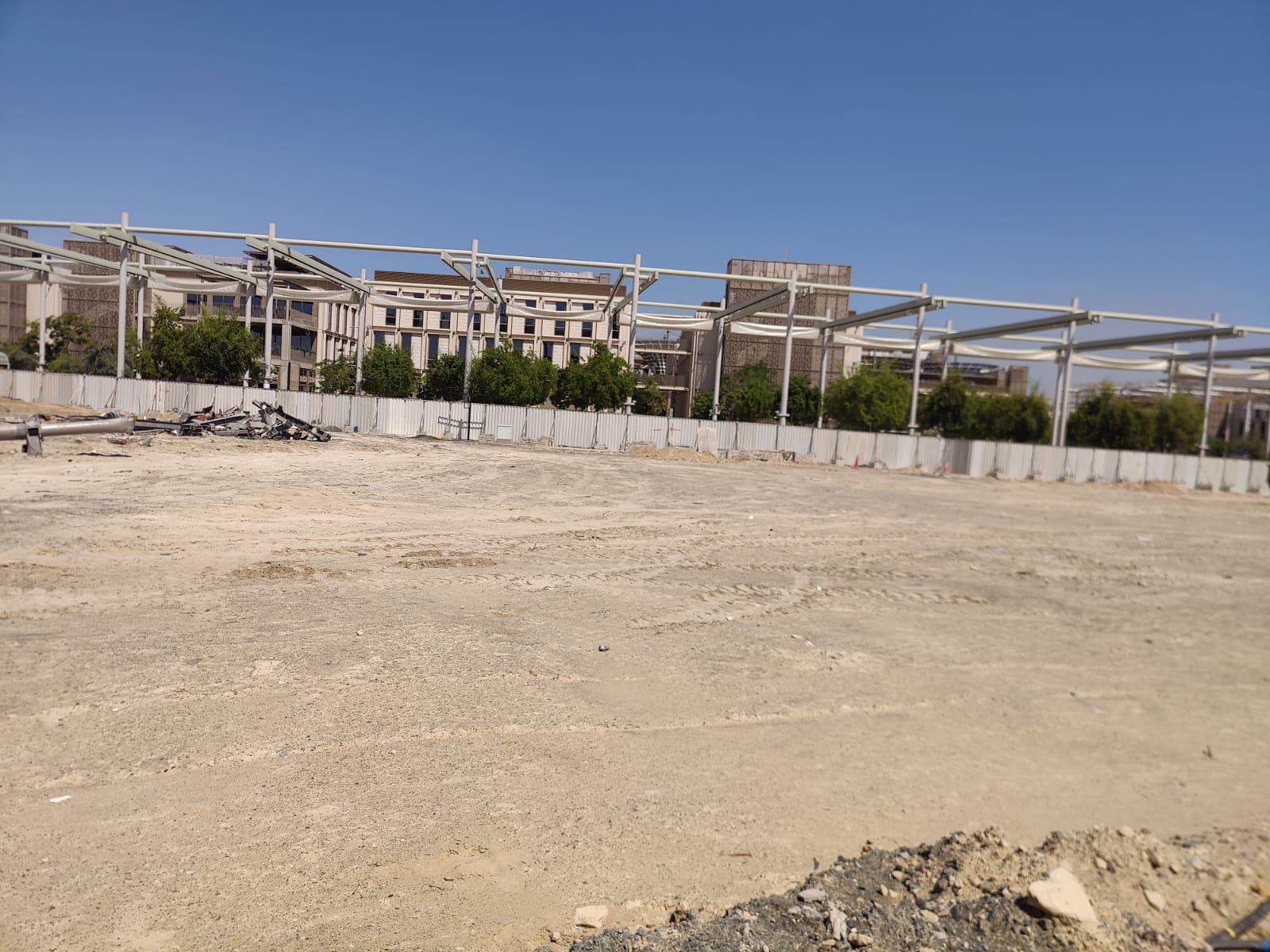 Poland Pavilion demolished site with cleared ground and overhead pergola structures