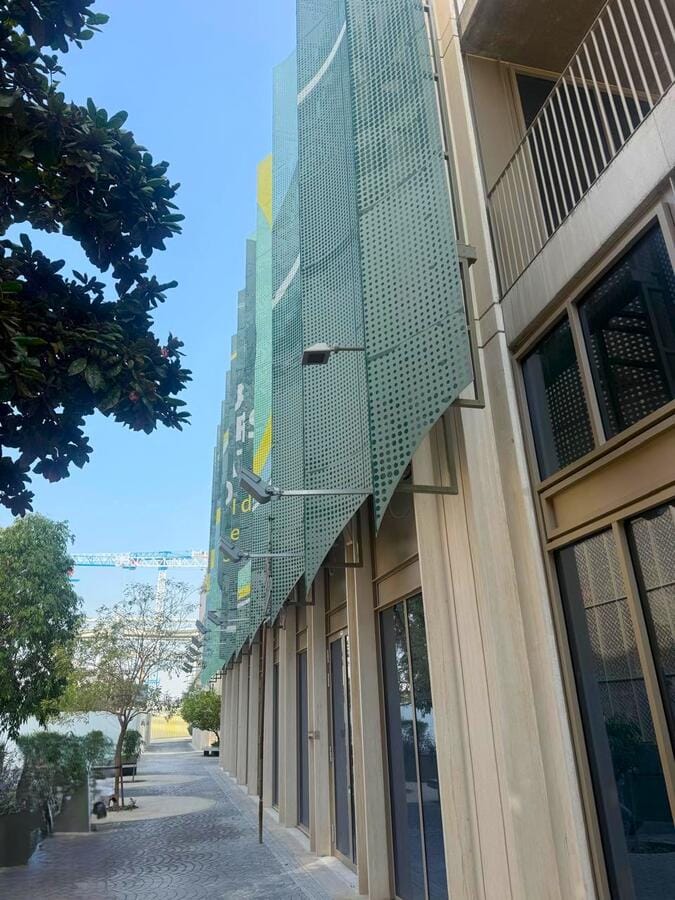 Green perforated facade cladding at Expo City Dubai building