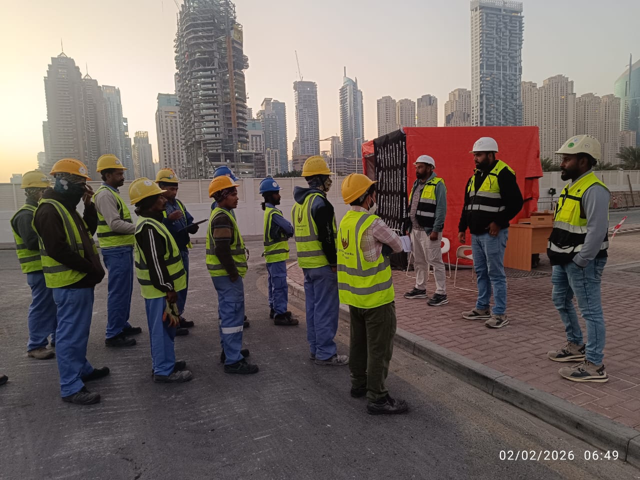 USF demolition team morning briefing at Zero Gravity Dubai with Dubai Marina skyline