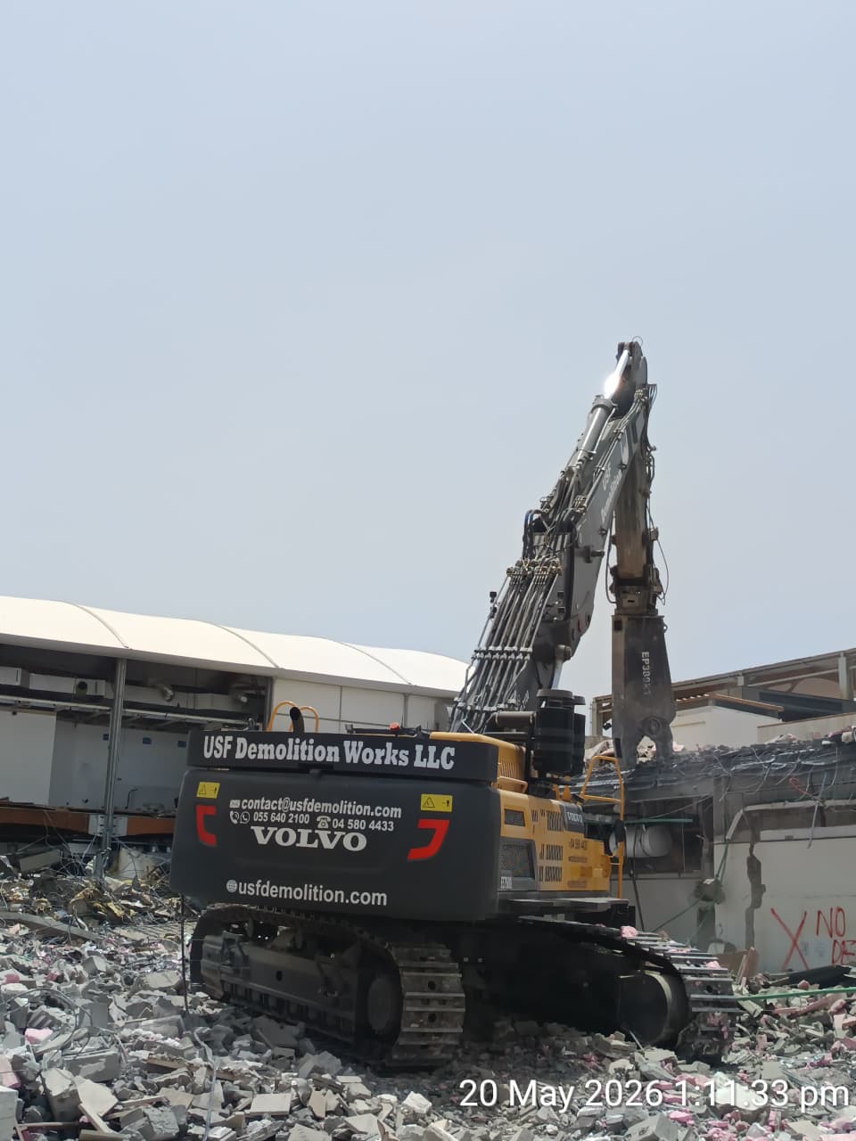 USF Demolition Works Volvo high-reach excavator processing concrete and steel debris at Zero Gravity Dubai Marina demolition site