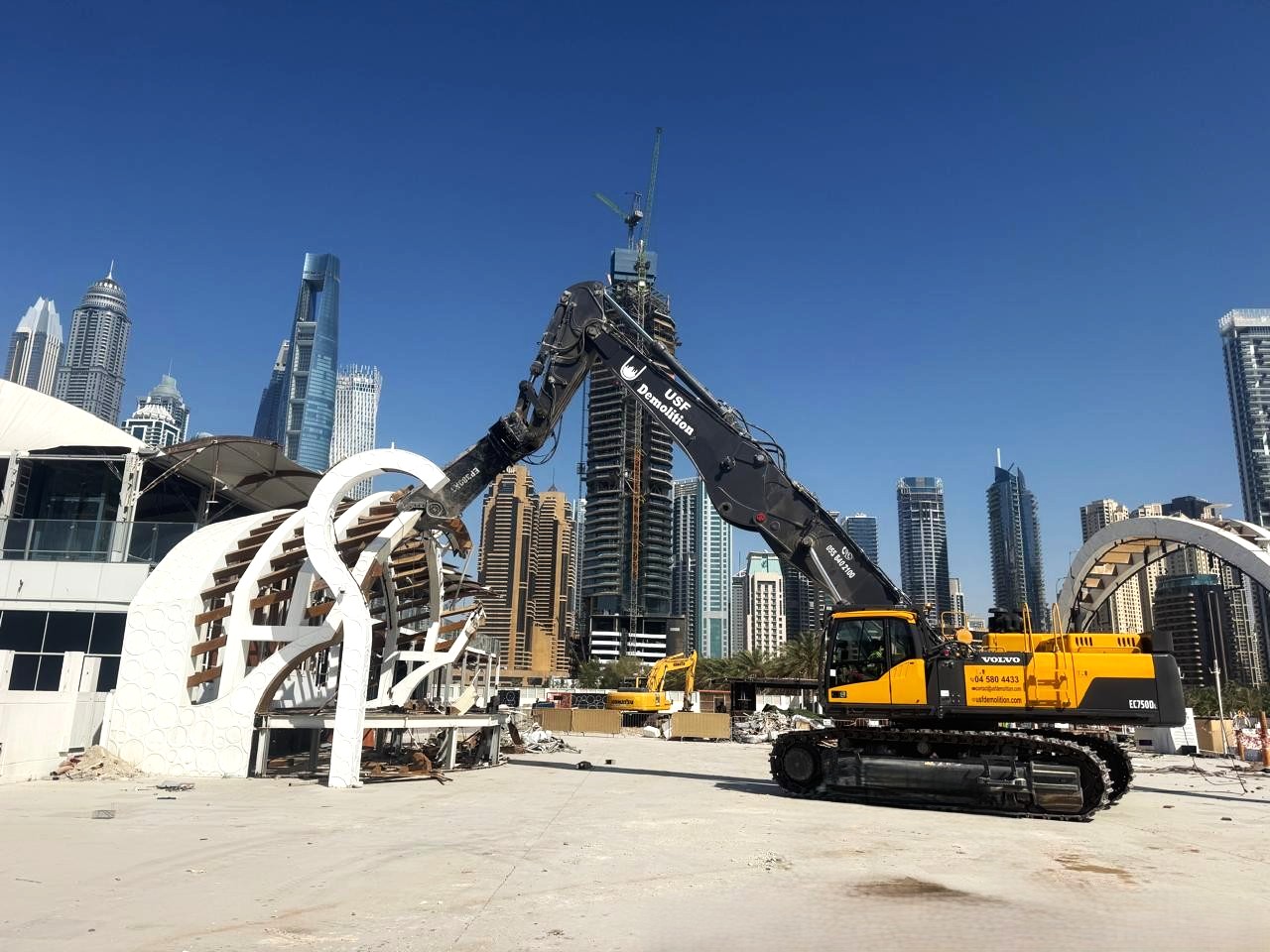 USF Demolition Volvo EC750D long-reach excavator dismantling tensile-canopy architectural feature at Zero Gravity Dubai Marina