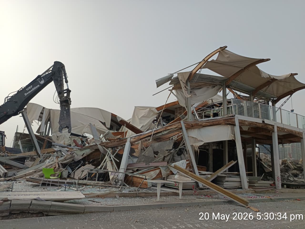 USF Demolition breaker excavator collapsing wooden roof structure of Zero Gravity main venue Dubai Marina